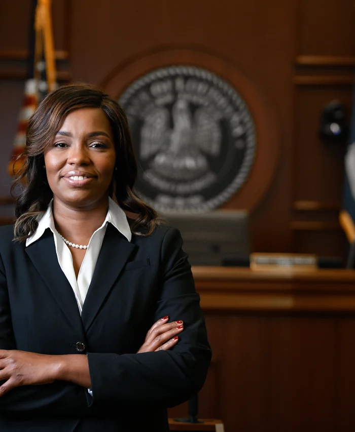 Judge Kimya M. Holmes in the courtroom in front of the Louisiana state seal